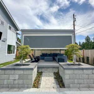 Motorized solar shade halfway down on custom pergola
